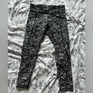 Black and white pattern Lululemon running leggings with side and back zip pocket